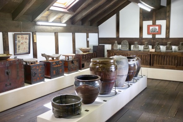 A collection of furniture, crocks and other things.