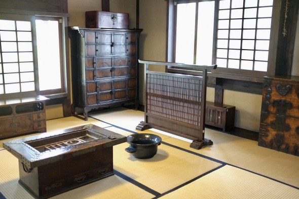 Tatami space complete with furniture and indoor fire pit.
