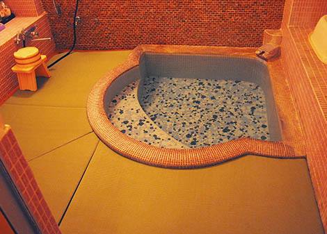 The private bath with a tatami floor and direct line from the natural hot spring.
