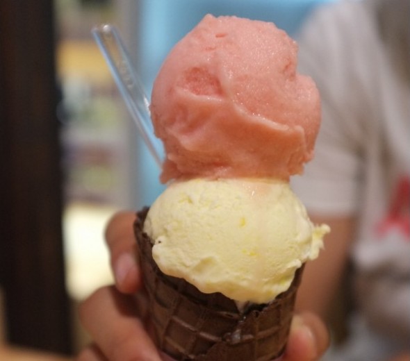 Watermelon and corn gelato in a chocolate cone