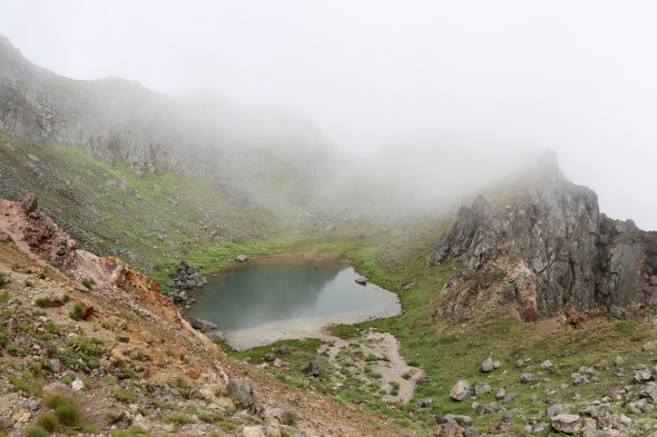 A cloudy view of the crater's lake from the peak.