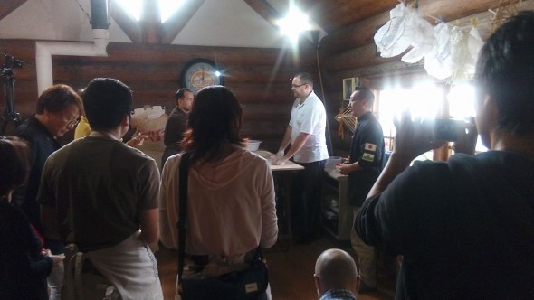 Participants eagerly watching the bakers demonstrate how to make the bread dough