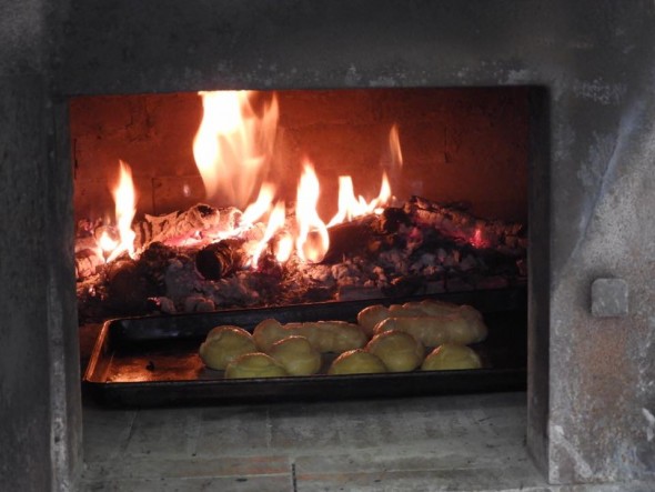 Eclairs and creme puff shells baking in the wood-burning oven