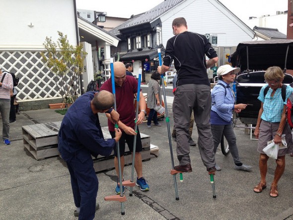 Visitors trying out the stilts - part of the old-fashioned Japanese toy corner
