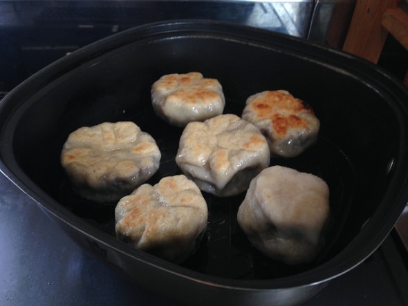Grilling oyaki in a frying pan