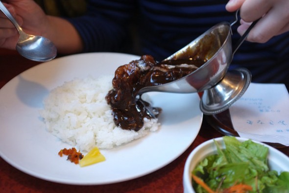 Pouring the chunky hayashi sauce over hot rice