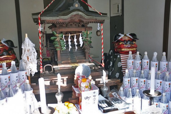The mikoshi set up as an altar in Nakamachi surrounded by sake and the "shishimai" lion dance costumes